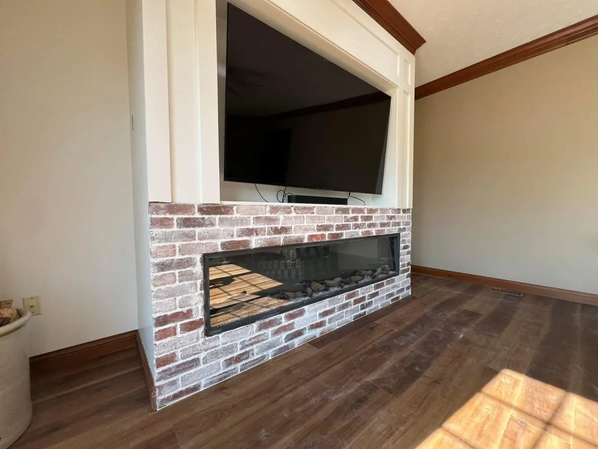 Finished fireplace with brick surround by Jameson's Legacy Renovations, Dayton OH